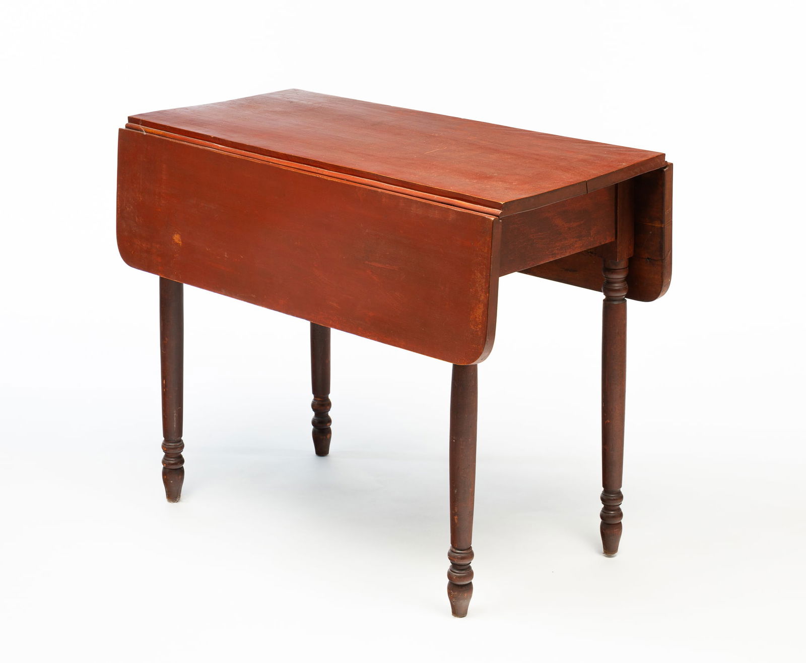 AMERICAN SHERATON RED-PAINTED WALNUT DROP-LEAF TABLE.: America, 19th Century. Walnut. Leaves with rounded corners, slender turned legs and old red paint. 28.75"h. 35.25"w. 35.75" open with 9.75" leaves.