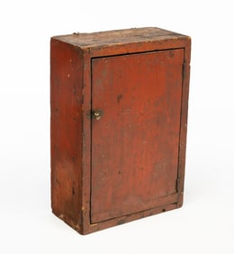AMERICAN REDDISH-BROWN PAINTED PINE HANGING CUPBOARD.