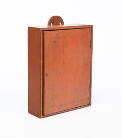 AMERICAN REDDISH-ORANGE PAINTED PINE HANGING CUPBOARD.