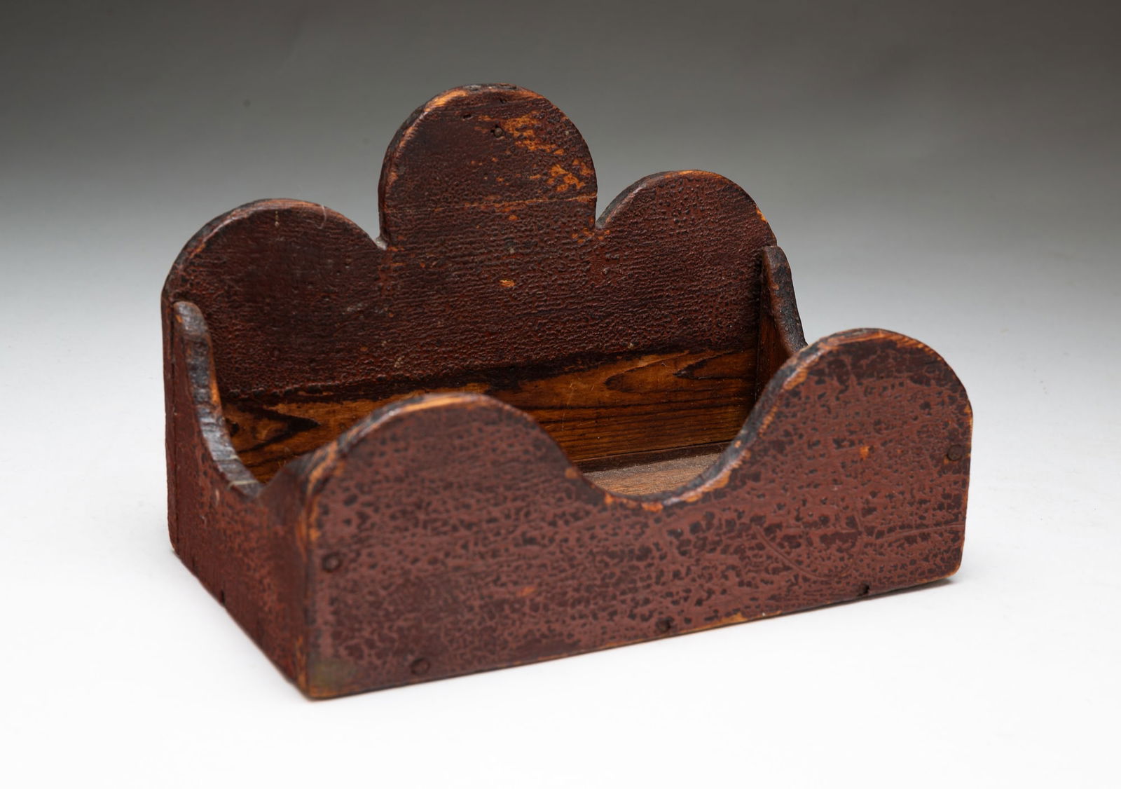 DIMINUTIVE PAINTED WOODEN WALL BOX.: American, 19th Century. Pine. Nailed construction. Arched crest top and front with alligatored red surface. 5.75"h. 8.5"w.