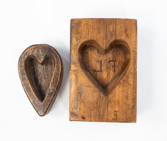 TWO AMERICAN HEART-CARVED MAPLE SUGAR MOLDS.