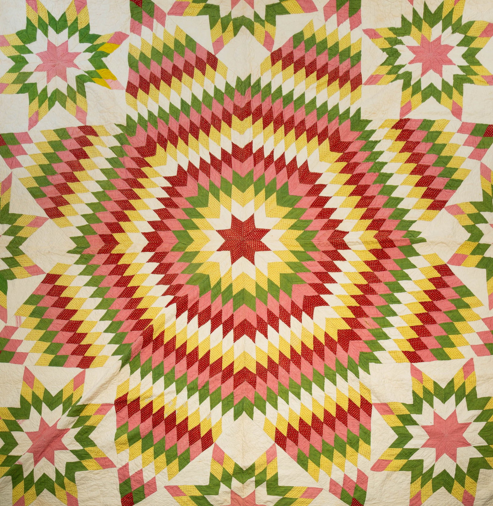 AMERICAN PIECEWORK STAR VARIANT QUILT.: American, Late 19th Century. White ground with stars in yellow, pink, red and green patterned fabrics with green piping. 92"w. 96"l.