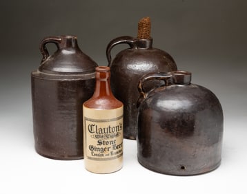 THREE AMERICAN GLAZED STONEWARE JUGS PLUS CLAYTON'S GINGER BEER BOTTLE.