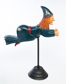AMERICAN CARVED AND PAINT-DECORATED CAROUSEL FLYING WITCH WITH STAND.