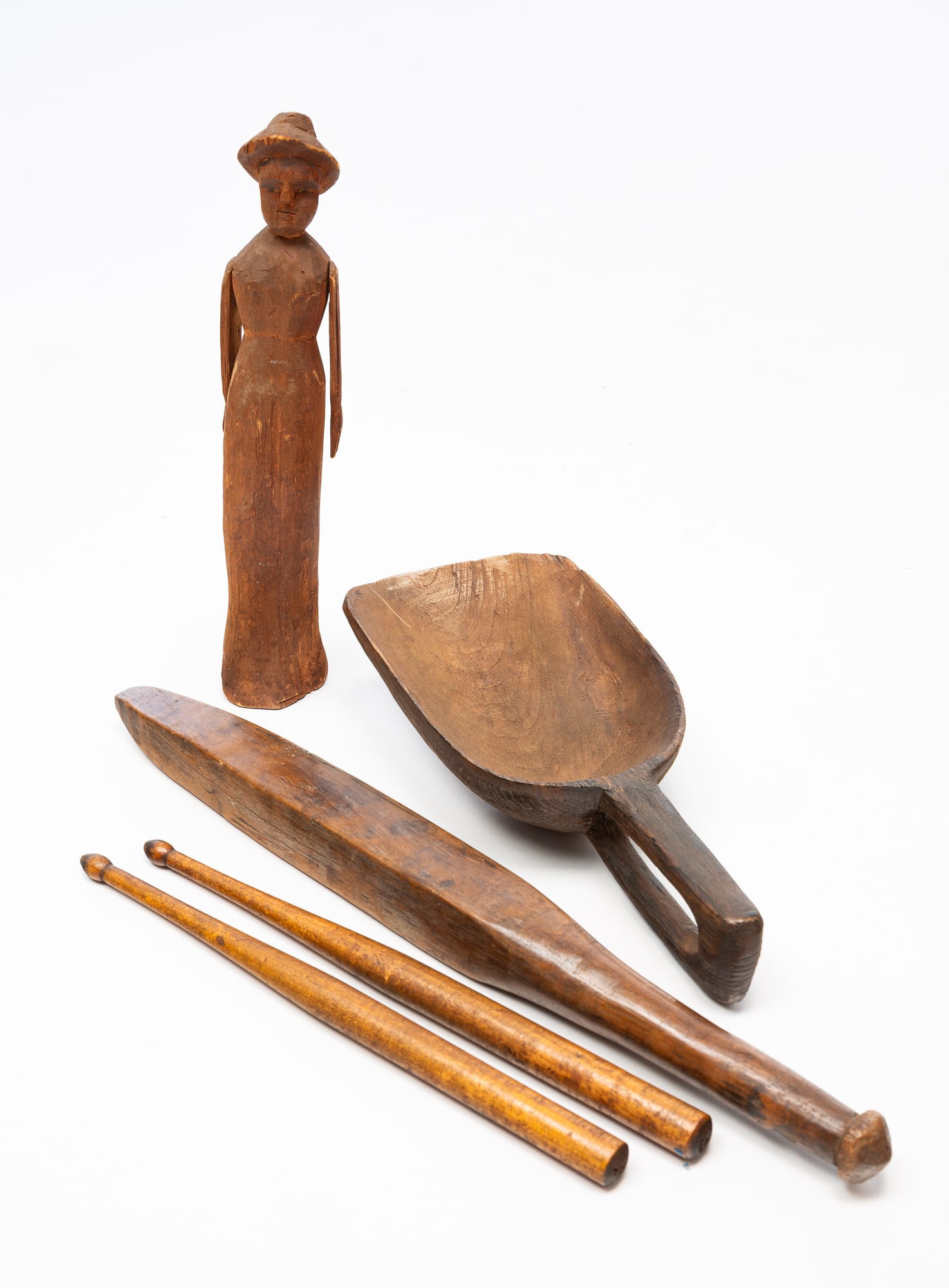 FOUR AMERICAN CARVED WOOD ITEMS, INCL. FOLK ART FIGURE.: American, 19th Century. Mixed woods. A nice form handled scoop, 11.5"l., a carved woman figure wearing a hat with whirligig arms, 12"h., a squared club with pointed end, 17.75"l. and a set of drumstic