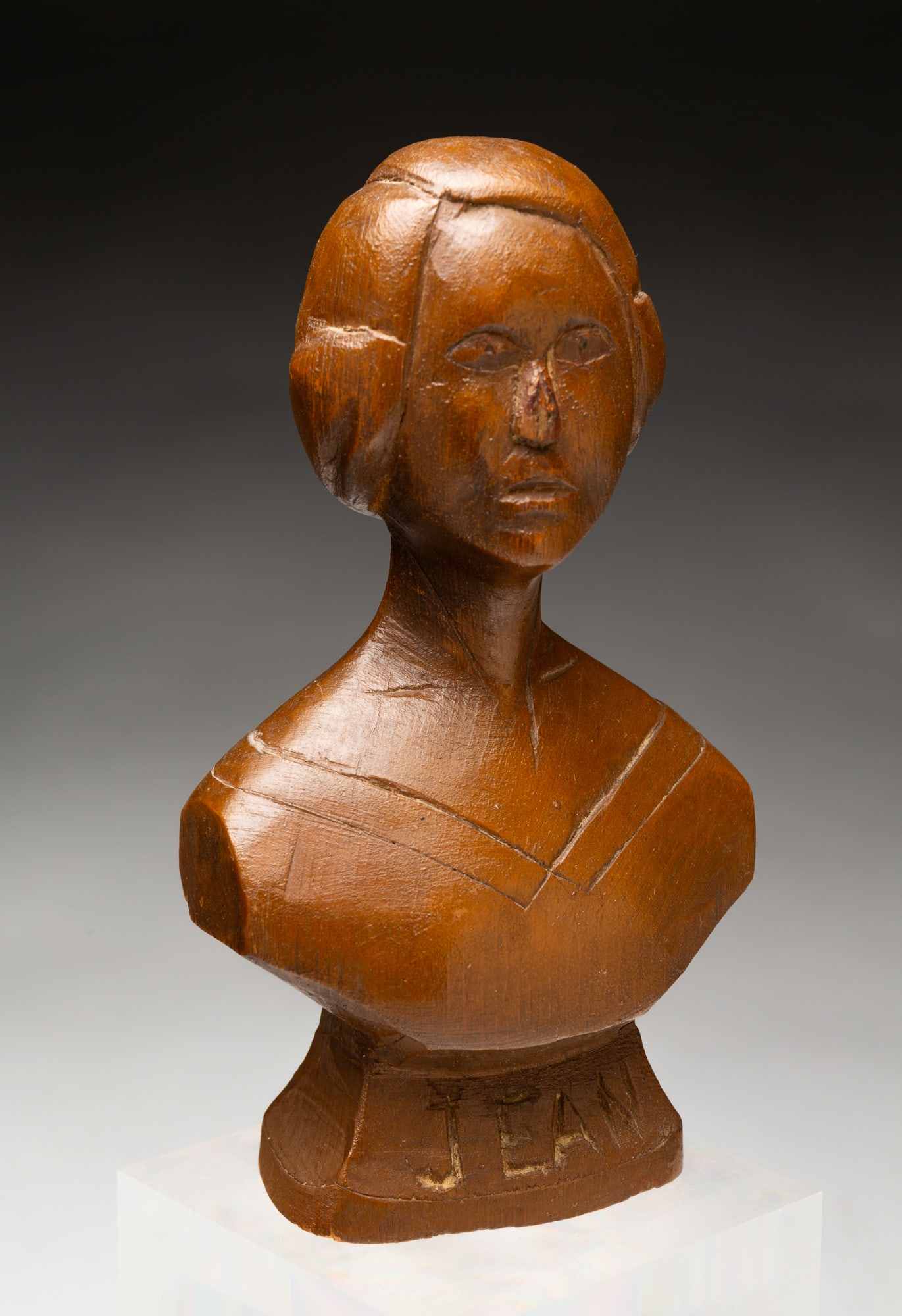 AMERICAN FOLK ART CARVED PINE BUST OF "JEAN".: American, 20th Century. Pine. Carved from a single piece with a nice stain. 6"h. 3.5"w. 2"d.