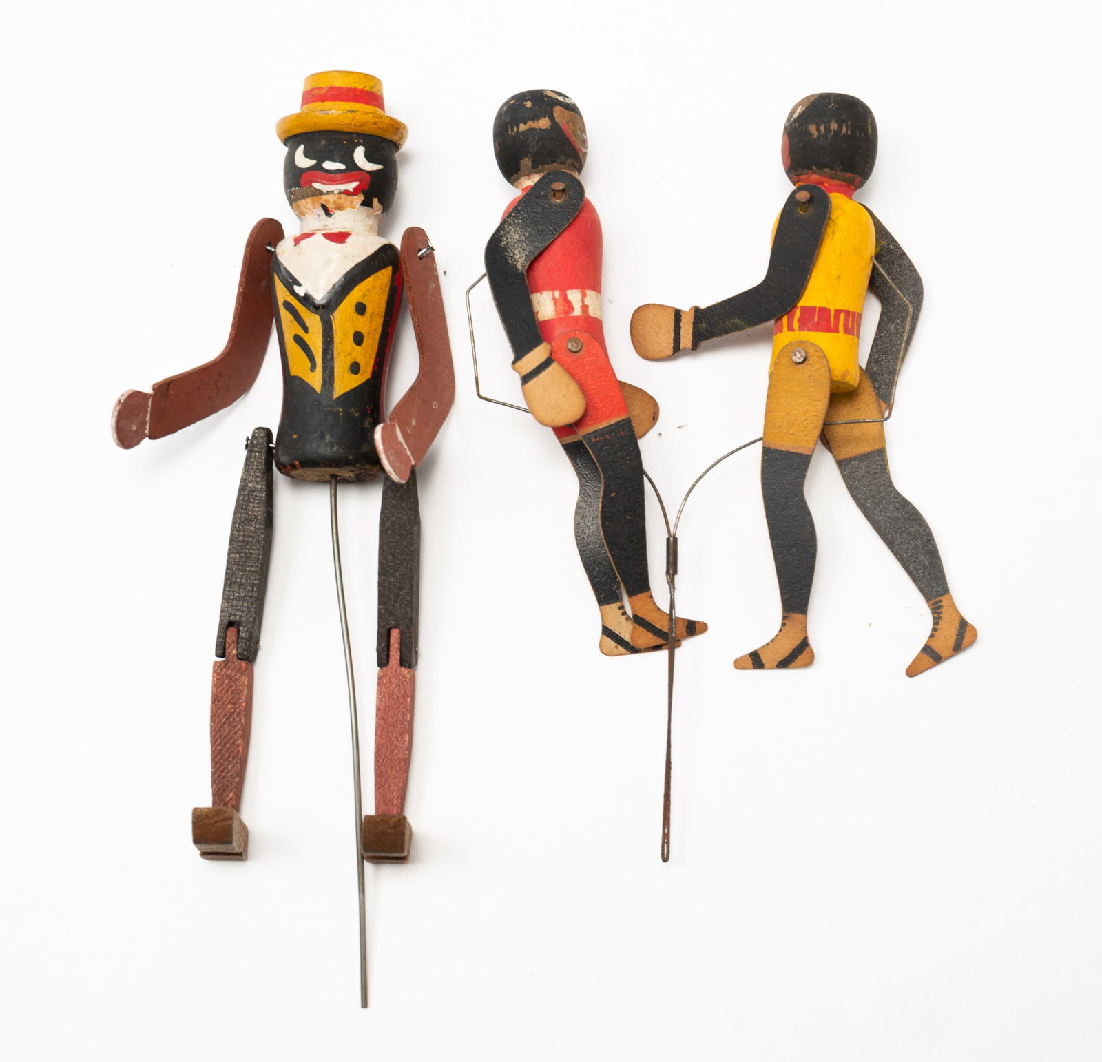 THREE AMERICAN FOLK ART PAINTED AND ARTICULATED DANCING FIGURES.: American, Early 20th Century. A painted wood articulated figure on wire, 6.25"h. Together with two articulated painted figures on a single wire. 5.25"h.Provenance: From the Lifetime Collection of Chuc