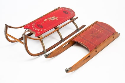 TWO AMERICAN PAINT-DECORATED WOOD SLEDS, INCL. ONE WITH STENCILED HOCKEY SCENE.