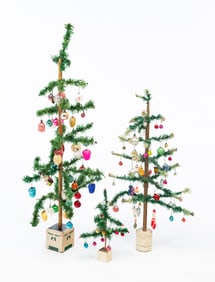 THREE DIMINUTIVE FEATHER CHRISTMAS TREES WITH ORNAMENTS.