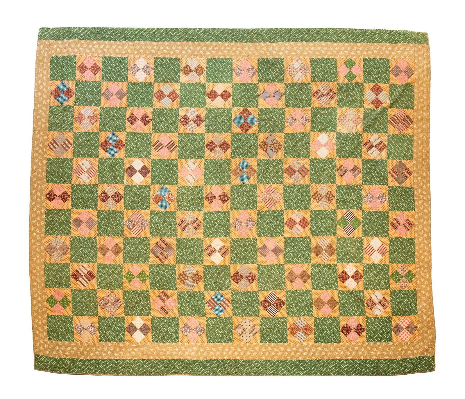 AMERICAN PIECEWORK PATCHWORK QUILT.: American, Early 20th Century. Cotton. Patchwork with various patterned squares, tan floral border and green top and bottom border. 73"w. 84"l.