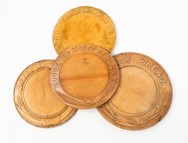 FOUR CARVED DAILY BREAD PLATES.
