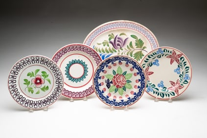 FOUR STICK SPATTER PLATES AND A PLATTER.
