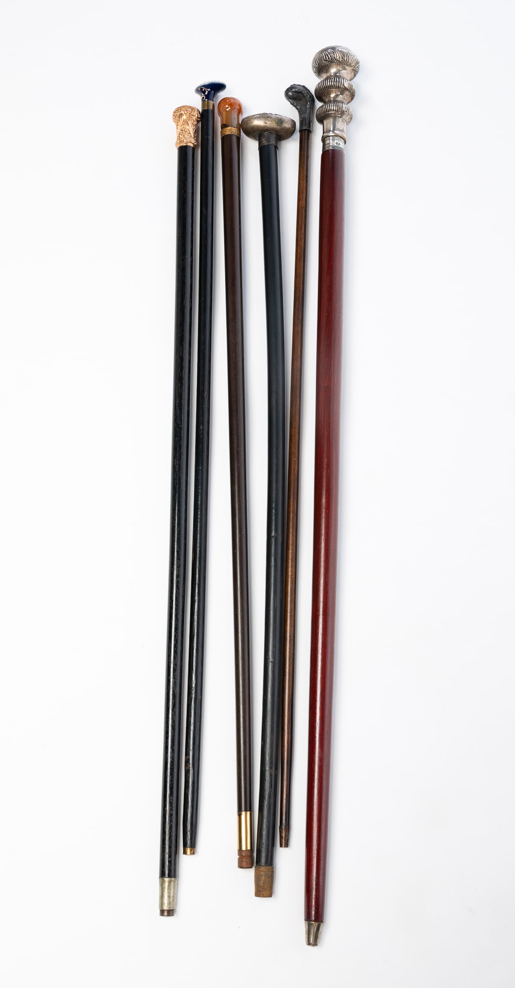 GROUP OF SIX WALKING STICKS, INCL. PRESENTATION AND AGATE-MOUNTED EXAMPLES.: Late 19th-Early 21st Century. Wood, metal, agate, and porcelain. Comprising three walking sticks with metal knobs, one of which has a label reading "ZODAX / MADE IN INDIA". Also included is an agate-m