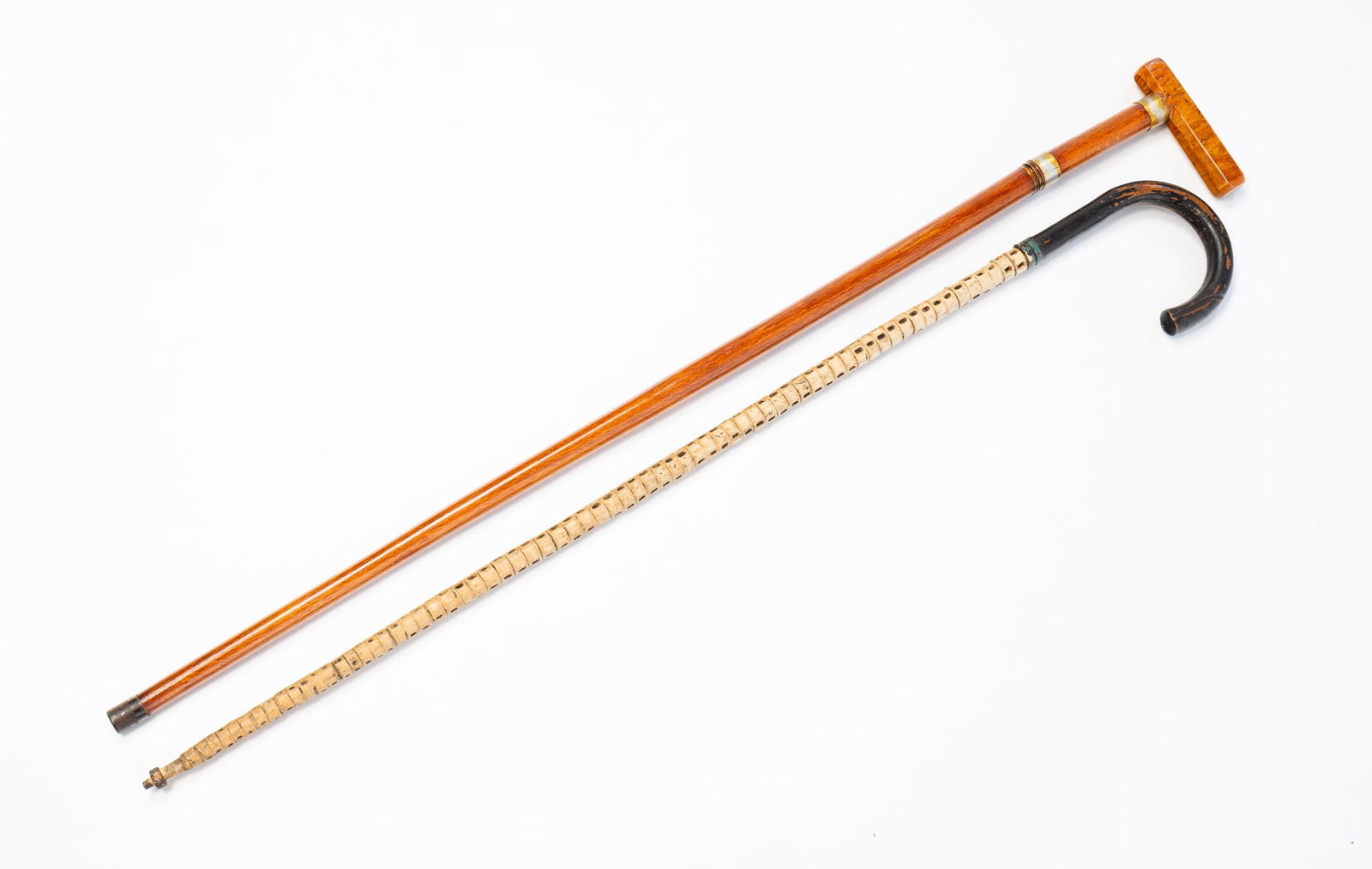 SHARK VERTEBRAE CROOK CANE PLUS GADGET CANE WITH TIGER MAPLE HANDLE AND HIDDEN FLASK.: 19th-20th Century. Wood, maple, shark vertebrae, and metal. The shark vertebrae cane comes with a later note stating it belonged to George Washington Tipton (1841-1891) who was the superintendent of a