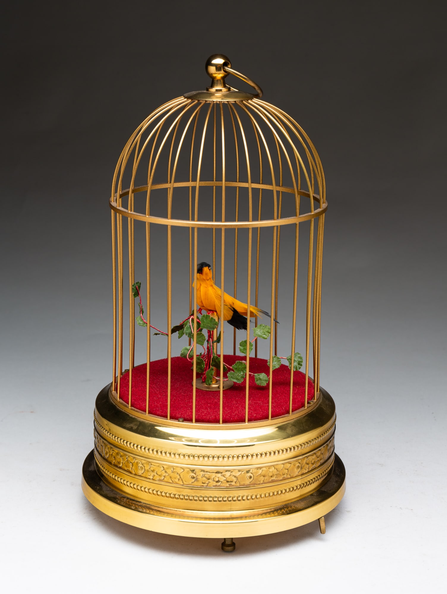 GERMAN BIRDCAGE AUTOMATON.: Germany, Second half 20th Century. Brass cage with single yellow and black bird. 10.5"h. 6.5"d.