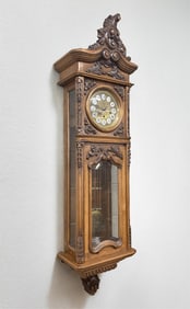 THE GAZO FAMILY CLOCK CO. (SAN DIEGO, CALIFORNIA) CARVED WALNUT WALL CLOCK WITH SEVENTY-TWO NOTE