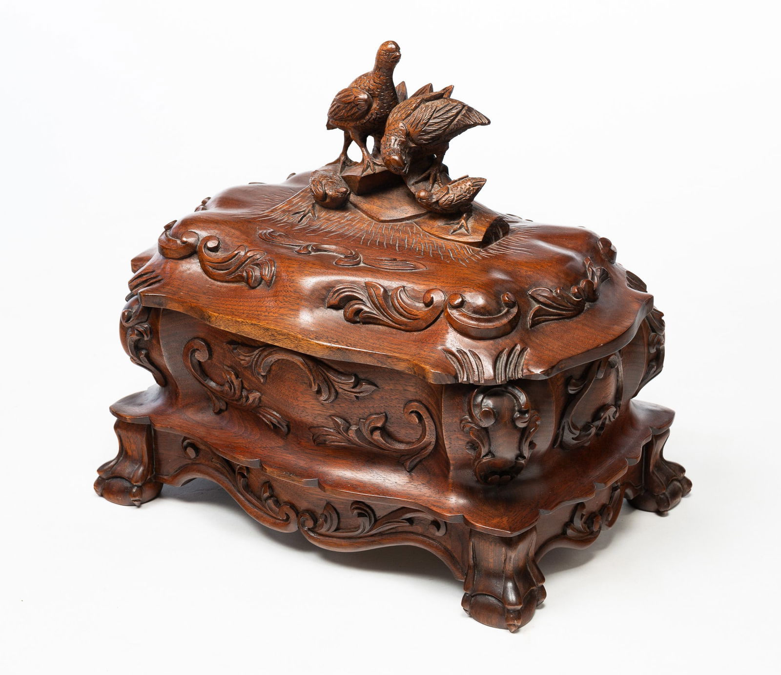 THE GAZO FAMILY CLOCK CO. (SAN DIEGO, CALIFORNIA) "QUAILS OF CARMEL" CARVED WALNUT MUSIC BOX, DATED: The Gazo Family Clock Co. (San Diego, California), dated (19)88. Heavily carved walnut case with bombe shape and quail family on lid. Seventy-two note Reuge movement with three Mozart tunes. Serial nu