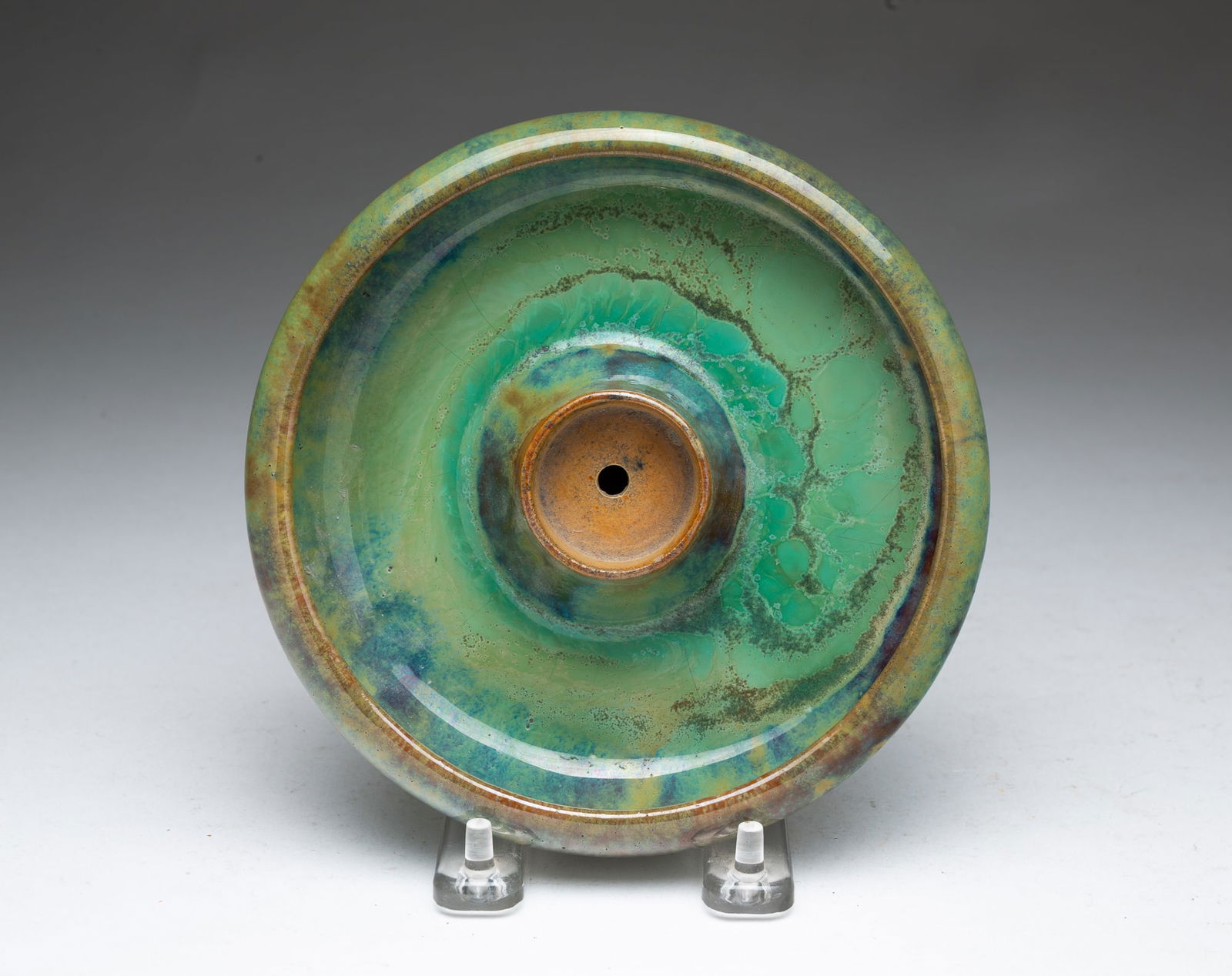 FULPER POTTERY CO. (FLEMINGTON, NEW JERSEY) ARTS AND CRAFTS GLAZED CANDLE HOLDER.: Fulper Pottery Company (Flemington, New Jersey), Early 20th Century. Round form with green glaze and signed on bottom. 1.5"h. 6.25"d".