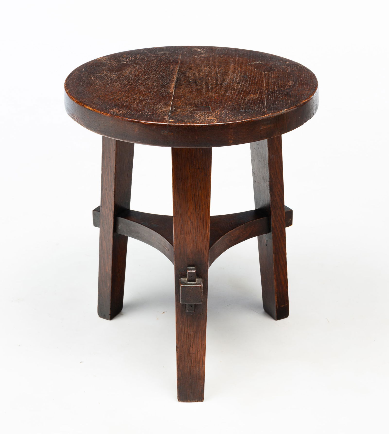 STICKLEY BROTHERS (GRAND RAPIDS, MICHIGAN) ARTS AND CRAFTS "NO. 314 1/2" QUARTERSAWN OAK TABOURET.: Stickley Brothers (Grand Rapids, Michigan), Early 20th Century. Number 314 1/2. Round form tabouret three splayed legs exposed flush through the top, keyed through tenon lower stretcher. Original fini