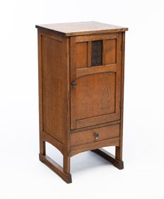 AMERICAN ARTS AND CRAFTS QUARTERSAWN OAK RECORD CABINET WITH RELIEF-CARVED DOOR PLAQUE.
