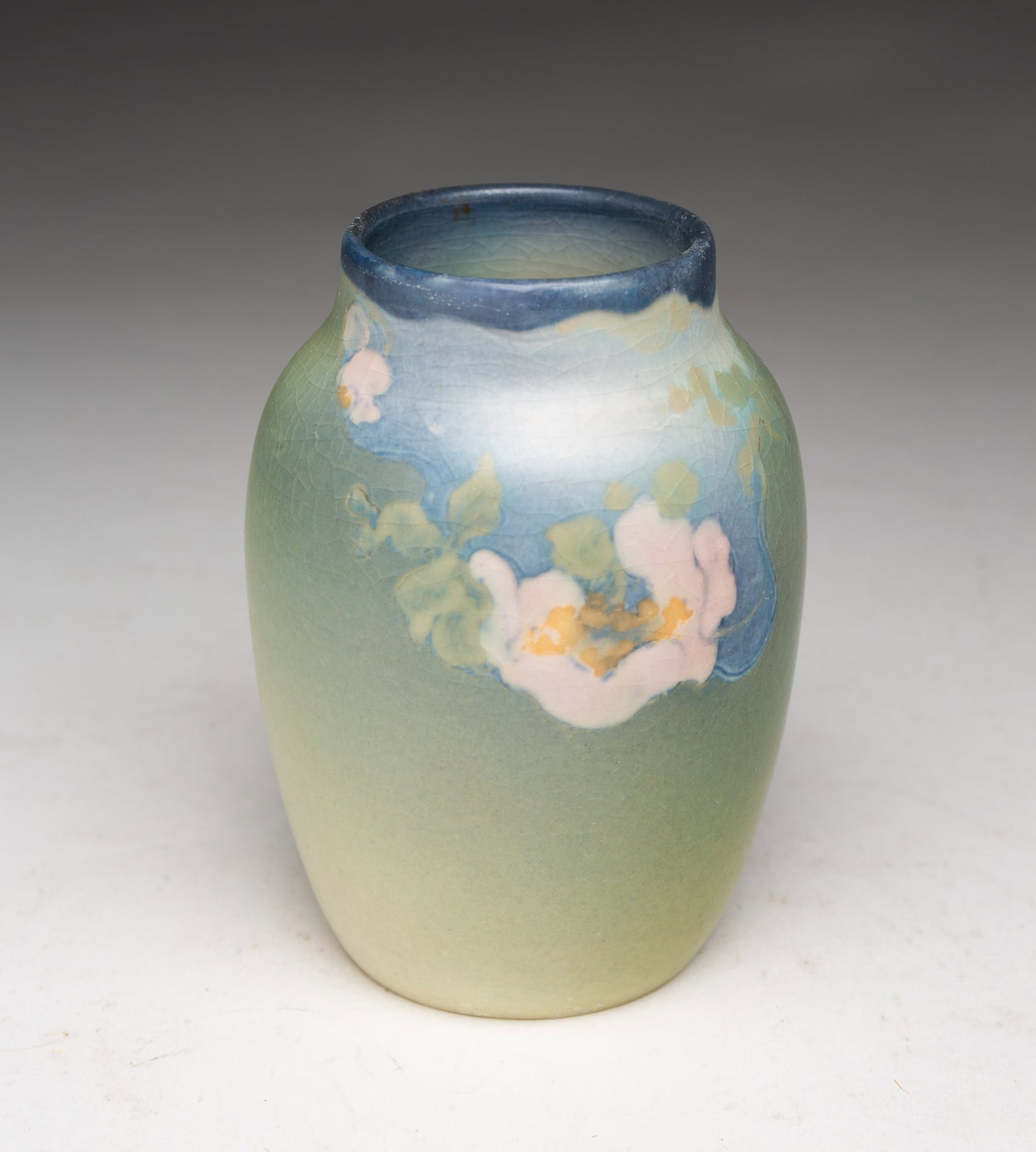 DIMINUTIVE ROOKWOOD ARTIST SIGNED VELLUM VASE.: American (Cincinnati, Ohio), Dated 1922. Typical vase form decorated with flowers on a green and blue ground. Marked to bottom and artist signed. 3.75"h. 2.75"d.