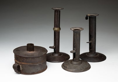 THREE AMERICAN TIN HOGSCRAPER CANDLESTICKS AND A TIN CANDLEHOLDER WITH TINDER BOX.