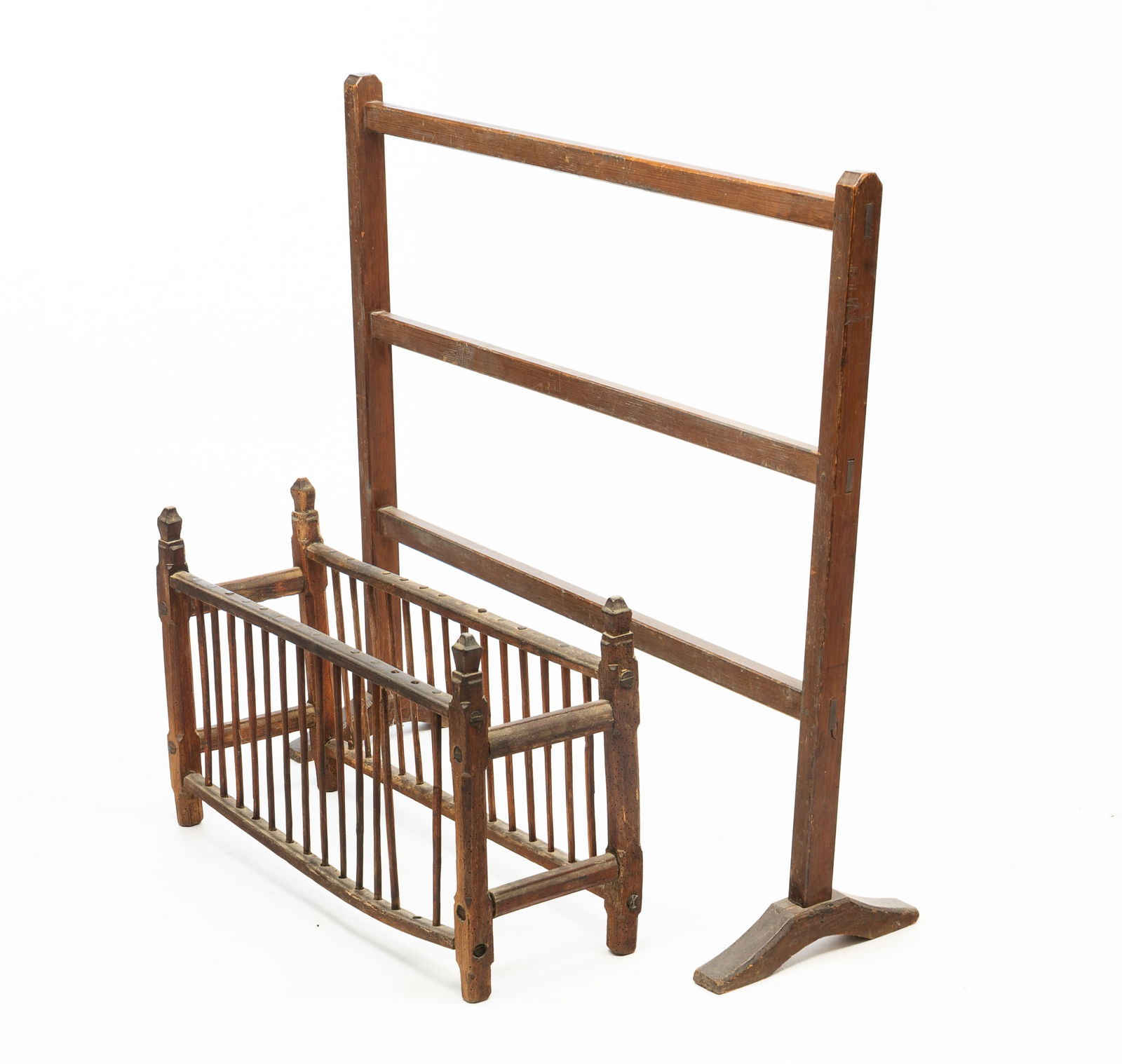 PEWTER PLATE DRYING RACK PLUS QUILT RACK.: European and American, 19th Century. A European standing wooden plate drying rack with peg construction and decorative finials. 16.5"h. 26.5"w. 9"d. An American three-rung wooden quilt rack of peg con