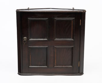 AMERICAN BROWN-PAINTED OAK HANGING CORNER CUPBOARD.