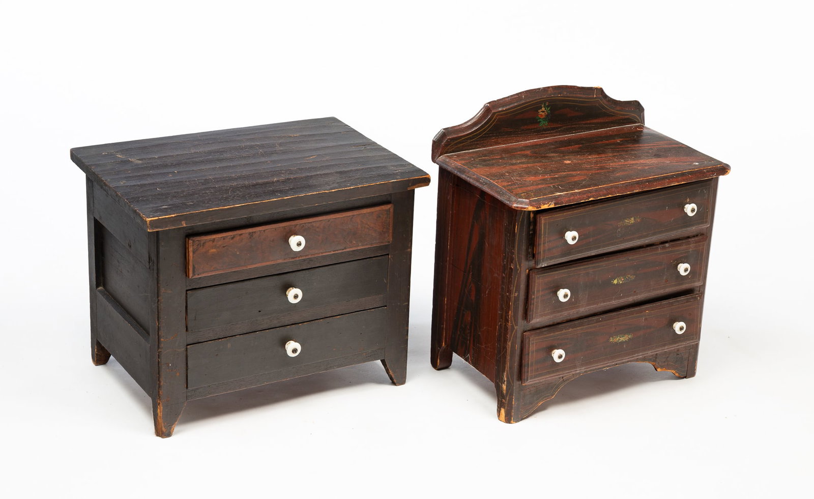 TWO AMERICAN CHILD'S THREE-DRAWER CHESTS.: American, 19th Century. A pine cottage Victorian three-drawer chest, shaped backsplash, overlapping drawers, red and black grain paint and gold pin striping. 14.75"h. 16"w. 9.25"d. And a poplar countr