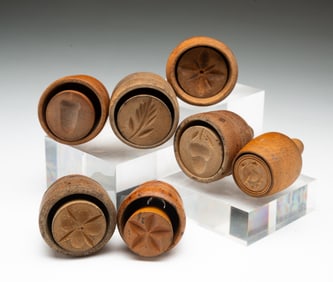 SEVEN DIMINUTIVE BUTTER PRINTS OR STAMPS.