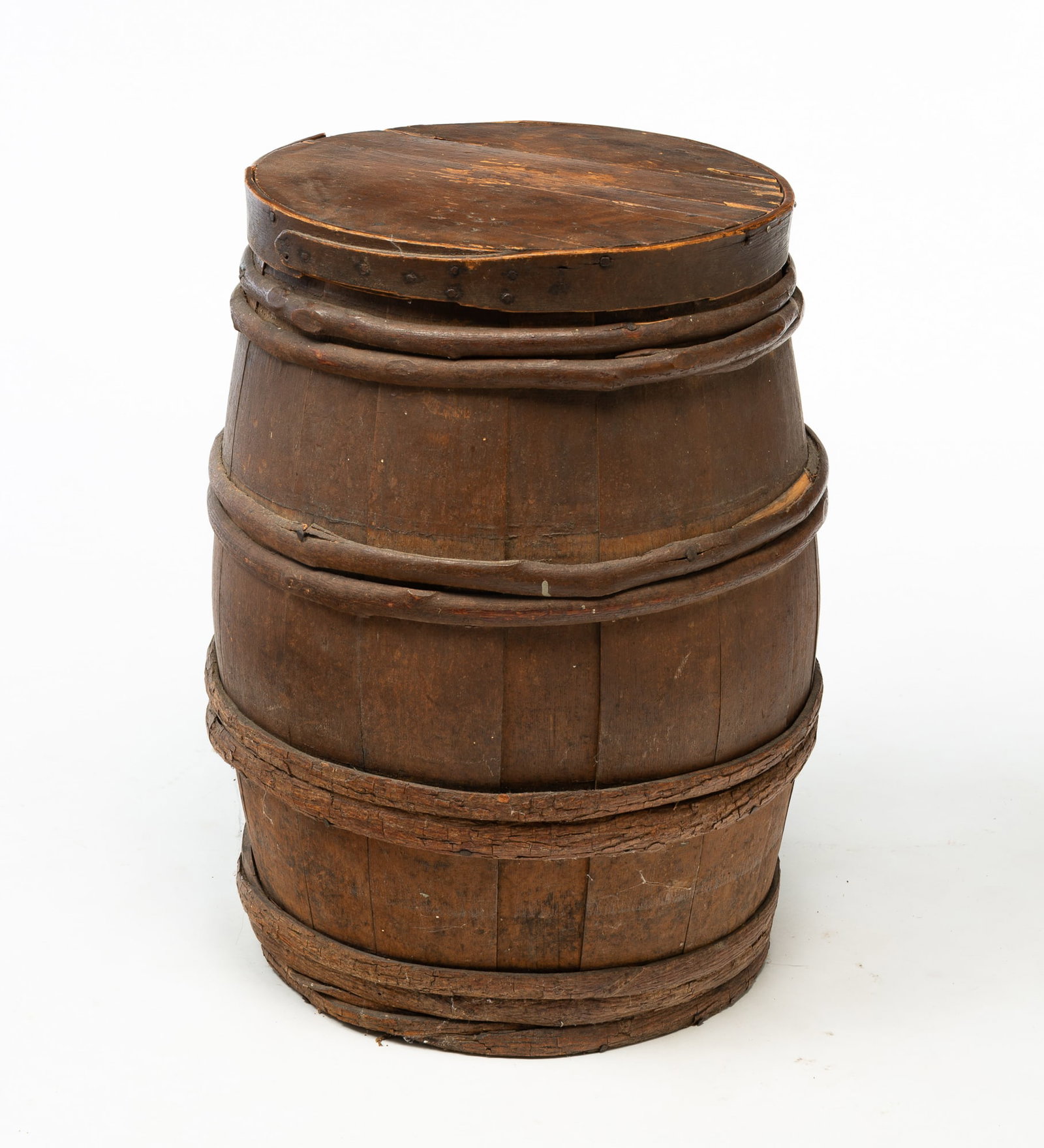AMERICAN PAINTED AND STAVED KEG WITH LID.: American, 19th Century. Pine. Stave constructed with grapevine hoops and original dark brown paint. 22"h. Head, 14.25"d.Provenance: From the Lifetime Collection of the late Joanne & David Hill (Arcanu