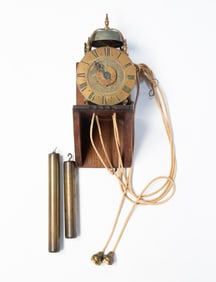 EUROPEAN BRASS LANTERN CLOCK WITH WOODEN WALL MOUNT.