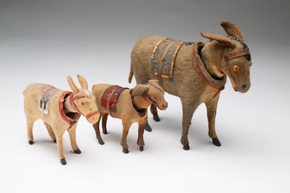 THREE GERMAN NODDING DONKEY FIGURINES.
