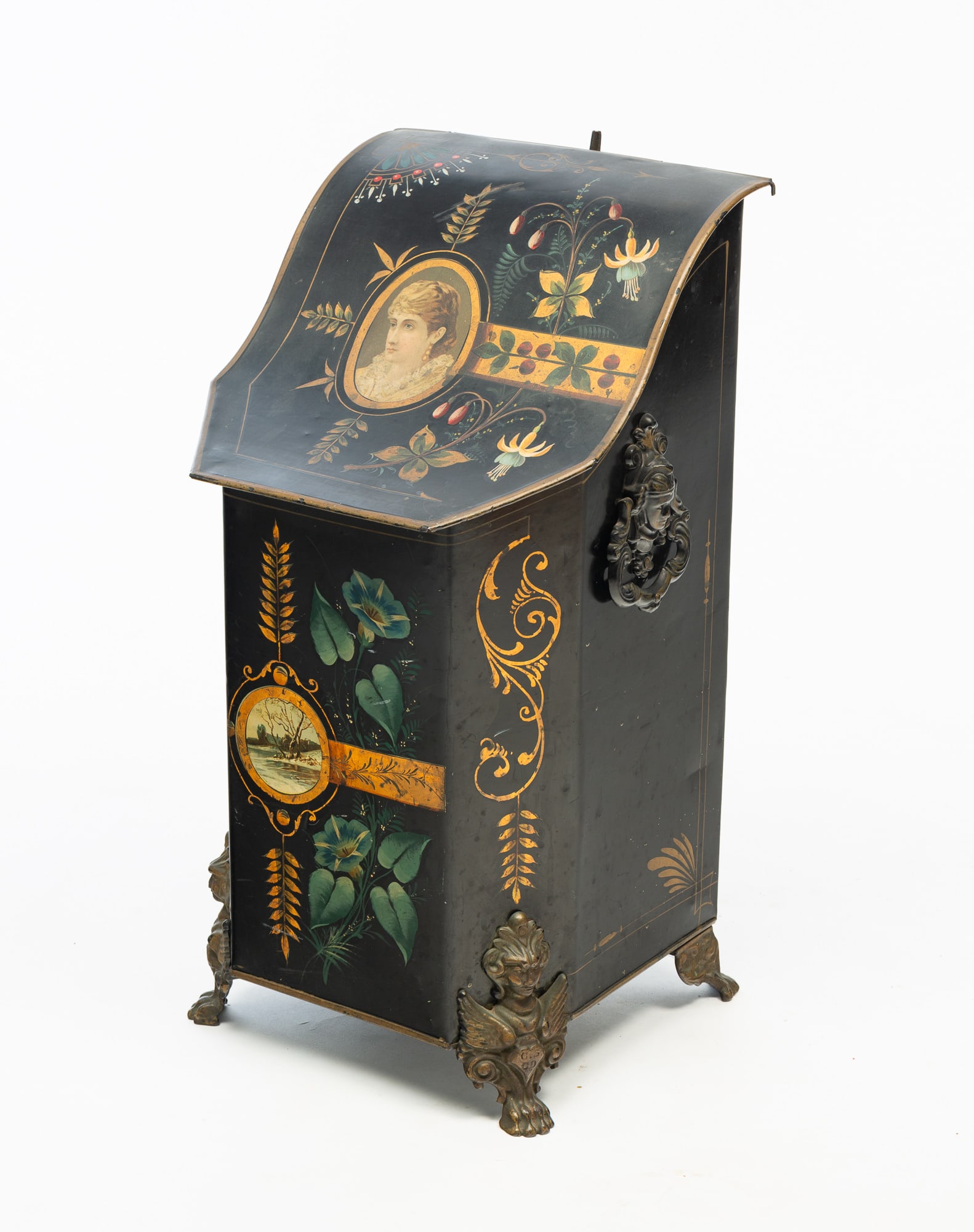 VICTORIAN TOLE-PAINTED COAL HOD WITH PORTRAIT AND LANDSCAPE MEDALLIONS.: American, Late 19th Century. Slanted lid, shaped front, cast iron handles and feet, all over black paint decorated with flowers, flourishes, a portrait to top and a scenic winter landscape reserve to 