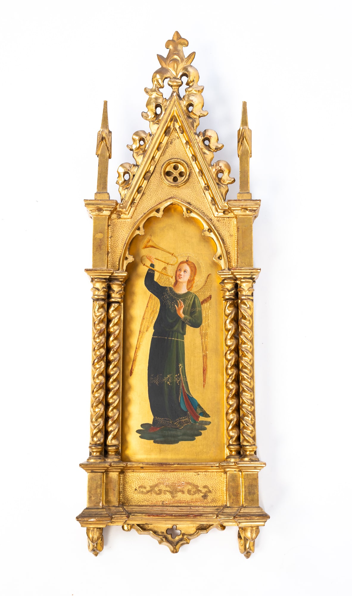 AFTER FRA ANGELICO (ITALIAN, 1395-1455) TEMPERA AND GILT ON PANEL OF AN ANGEL HOLDING A TRUMPET IN: Italy, ca. 1900. Tempera and gilt on panel. Depicting an angel with wings in a green gown holding a trumpet aloft, housed in an ornately carved gold leaf Gothic frame. 25"h. 8.75"w.Provenance: From th