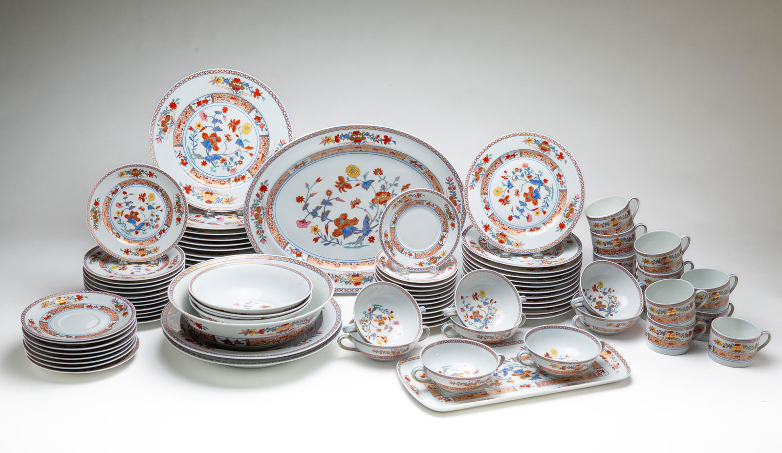 FRENCH BERNARDAUD LIMOGES "PONDICHERY" PATTERN CHINA.: France, 20th Century. Twelve dinner plates, twelve salad plates, twelve bread and butter plates, twelve cups and saucers, eight cream soups and under plates, oval platter, two shallow bowls, one large