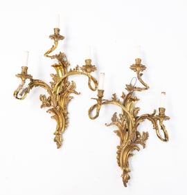 PAIR OF BAROQUE STYLE GILT BRASS ELECTRIC THREE-LIGHT WALL SCONCES.