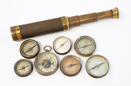 SEVEN BRASS POCKET COMPASSES PLUS TWO-DRAW SPYGLASS.