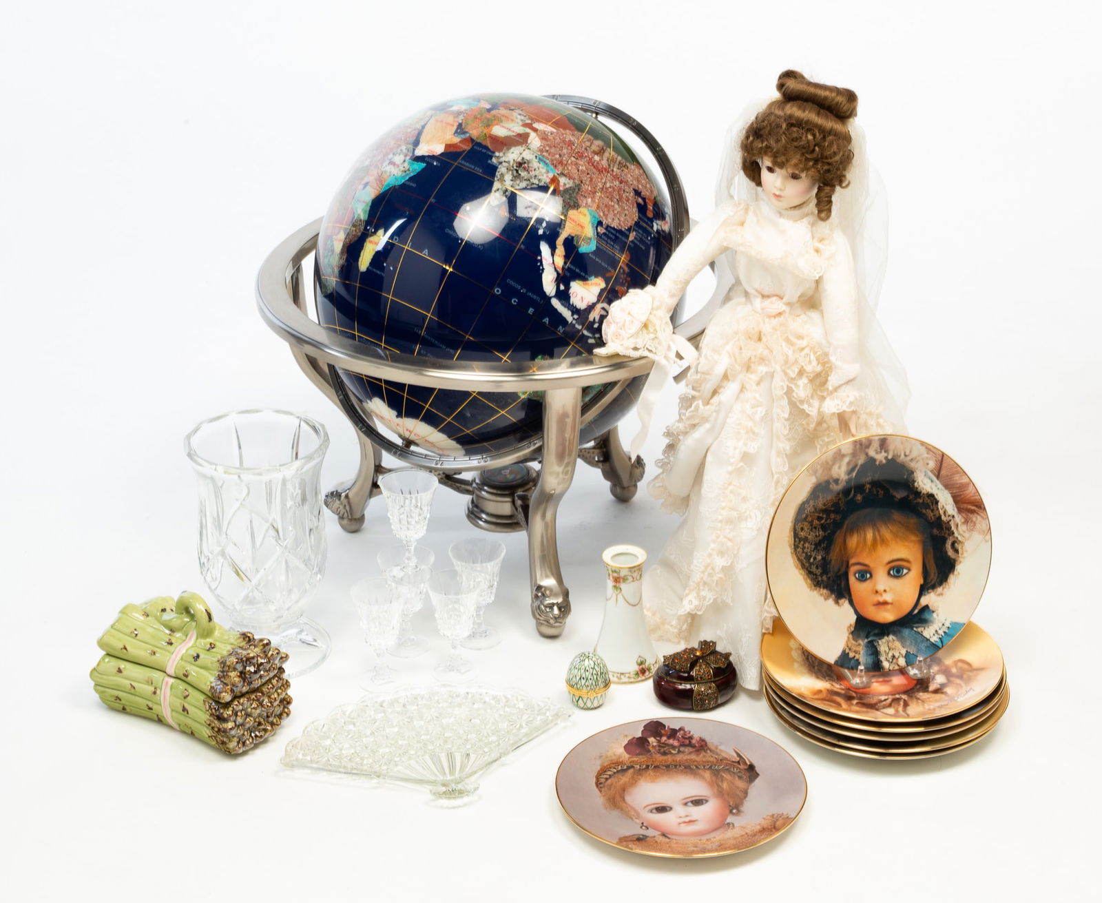DECORATIVE HOUSEHOLD ITEMS.: Contemporary. Including a glass footed vase, pressed glass fan tray, lidded majolica asparagus sauce dish, trinket boxes, glass cordials, a bisque head doll in a wedding dress marked 1987, seven Seele