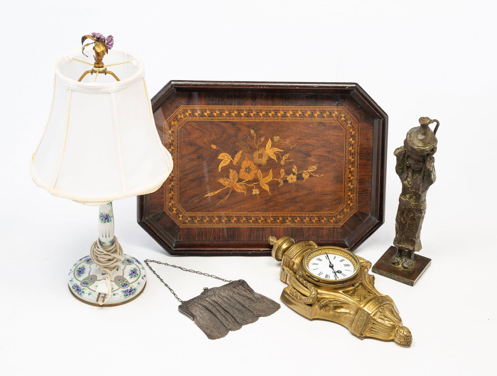 ECLECTIC CONTINTENTAL DECORATIVE GROUPING.: Twentieth Century. Including an octagonal wood tray with marquetry decoration, 20.25"w. 14.5"d., a brass wall clock, porcelain face with roman numerals, 15.5"h. 7.5"w., a bonzes statue of a child carr