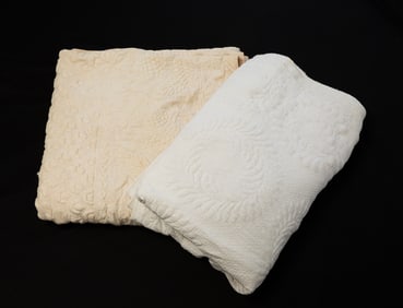 TWO AMERICAN HAND-STITCHED STUFFED QUILTS.