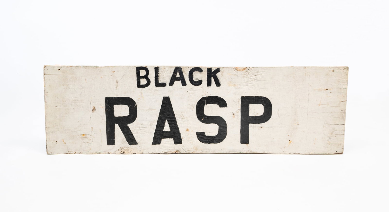 AMERICAN DOUBLE-SIDED FARM STAND SIGN.: America, Early 20th Century. Plywood. Rectangular sign in with paint and stenciled "PEARS" to one side and "BLACK RASP" to the other. 10.75"h. 36.5"w.Provenance: From the Lifetime Collection of Chuck 