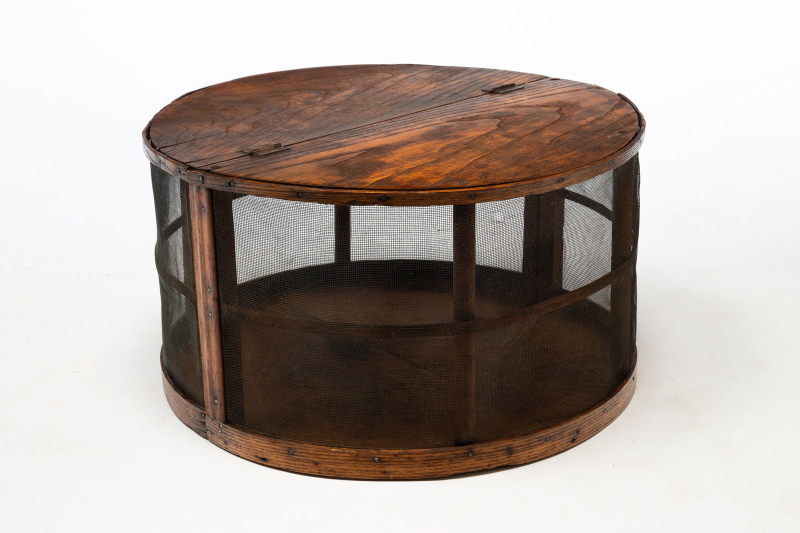 AMERICAN OAK, PINE, AND SCREEN-MOUNTED COUNTERTOP PIE SAFE.: America, ca. 1900. Oak and pine. Cylindrical shape with screened sides. 13"h. 24"d.