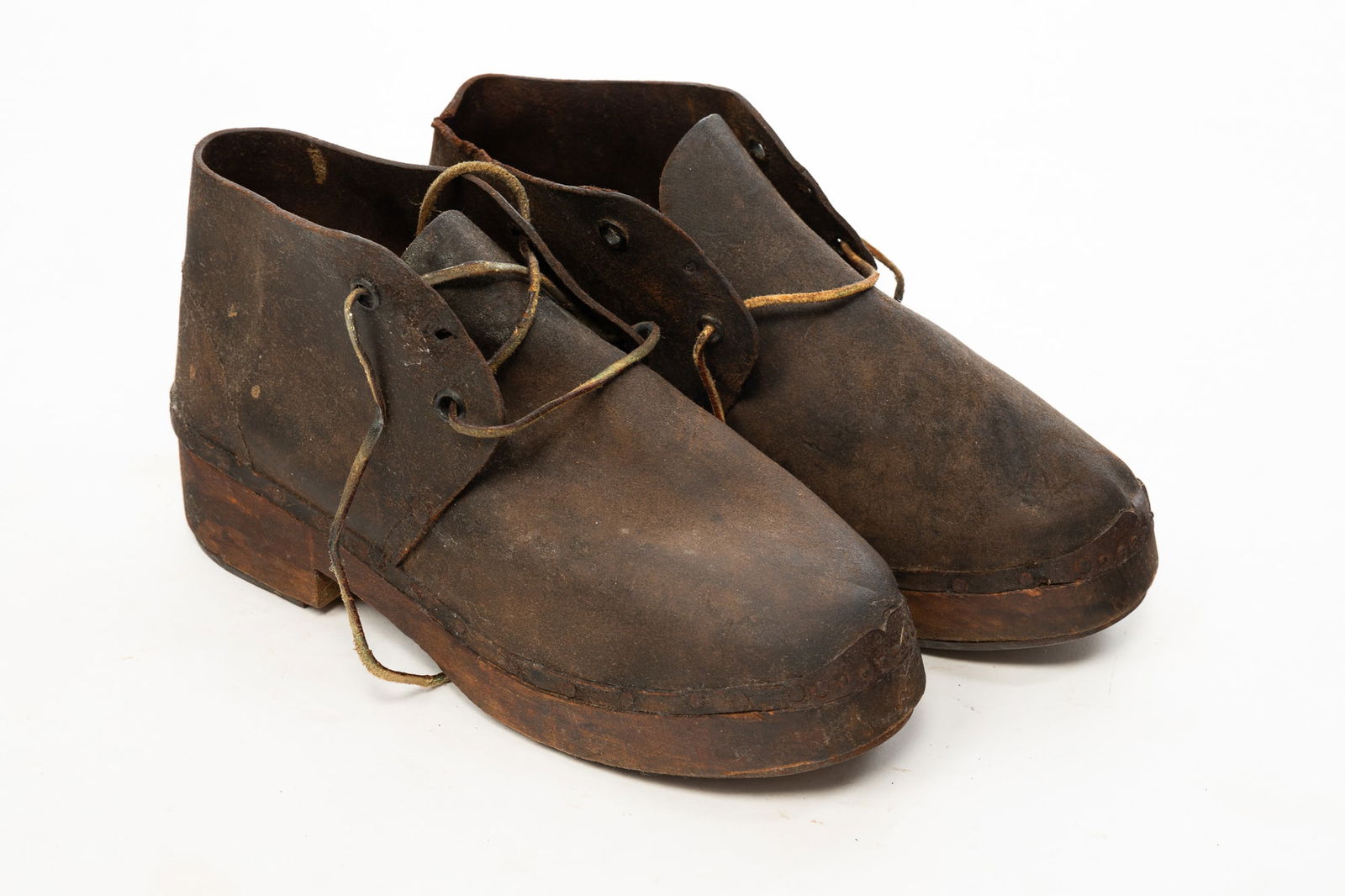 A.F. PUREJOY (FORRESTVILLE, NORTH CAROLINA) CAPTURED CONFEDERATE SOLDIER SHOES.: American, 19th Century. Leather upper with laces, one-piece wooden soles having heels reinforced with metal strips, one sole stamped "10" and "Purejoy." 6"h. 11.5"w.Provenance: From the Lifetime Colle