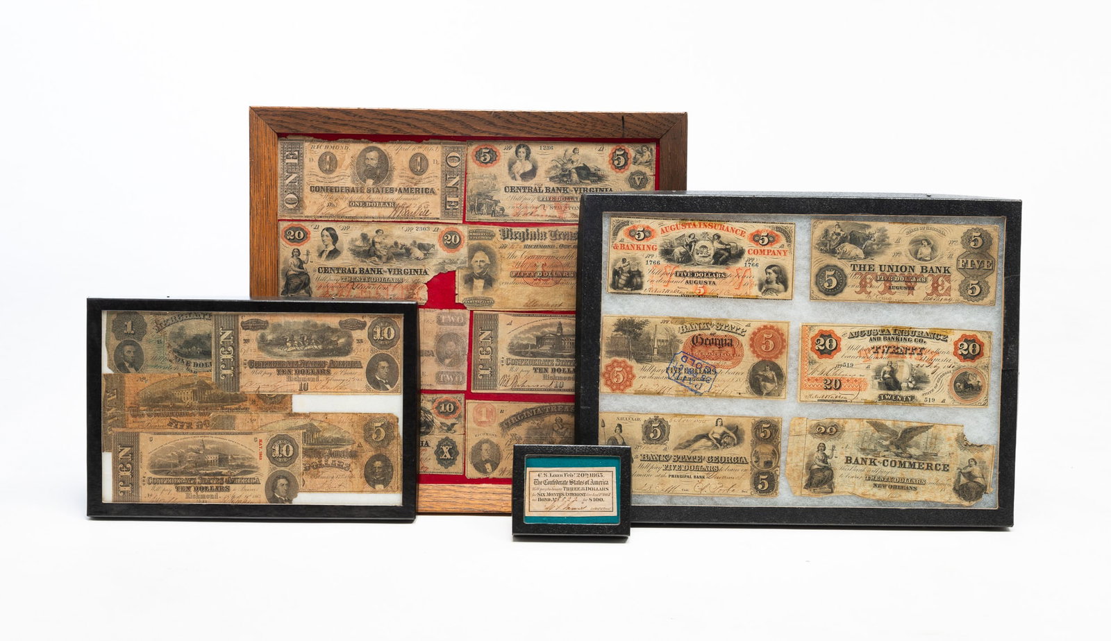 FRAMED CONFEDERATE STATES OF AMERICA CURRENCY AND SOUTHERN STATES' BANK NOTES.: American, Mid 19th Century. Comprising four framed items: two frames of Confederate States of America currency and two frames of Southern state bank notes. Largest frame, 15.25"h. 16.25"w.Provenance: 