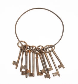 GROUP OF ELEVEN IRON SKELETON KEYS ON IRON HOOP.