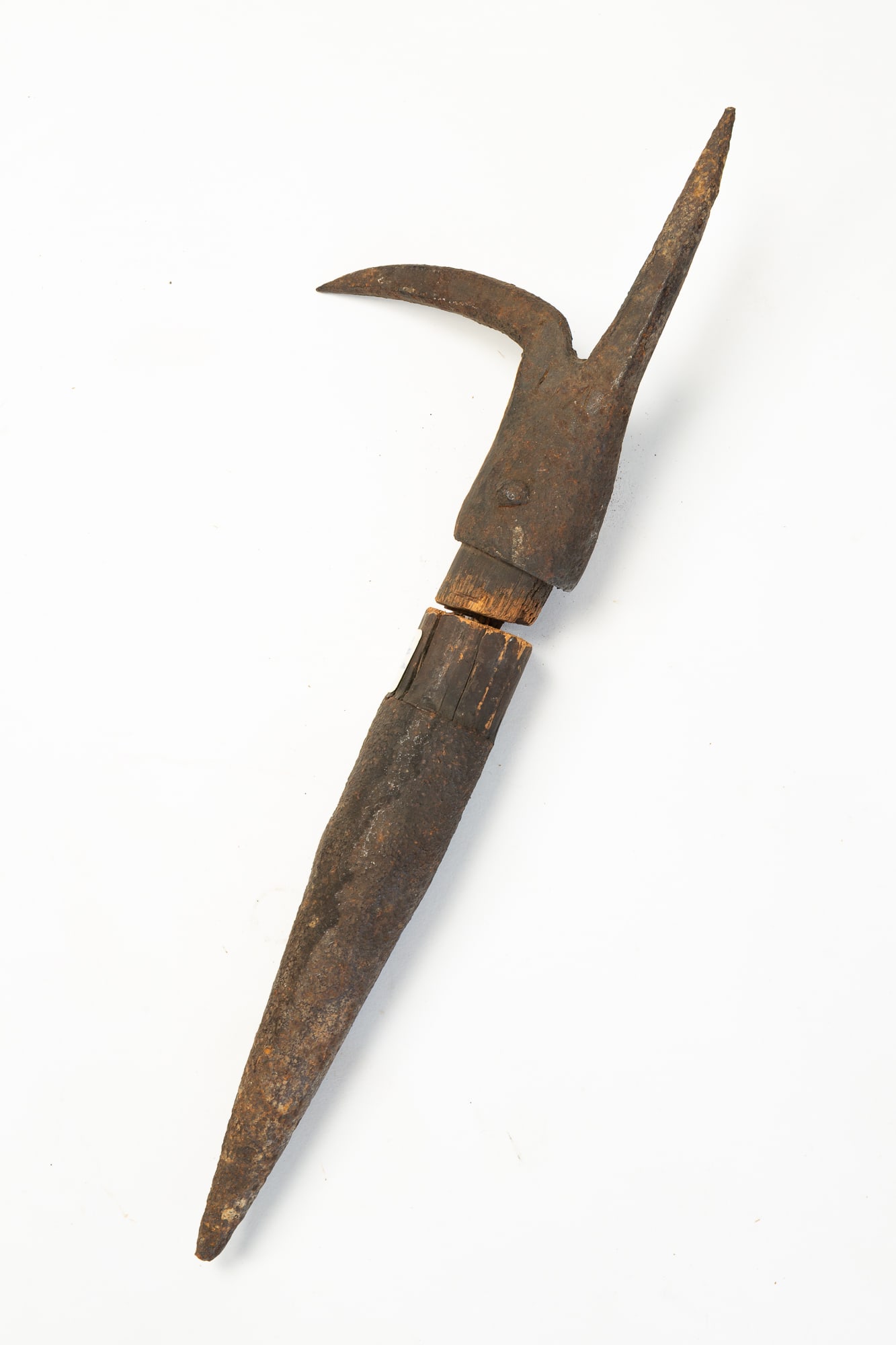 FORGED IRON BOARDING HOOK.: European or American, Late 18th Century. Iron cone-shaped pike end with curved and straight spike. Missing wooden standard. 16.5"l.Provenance: From the Lifetime Collection of the late Ken Hanna (Chest
