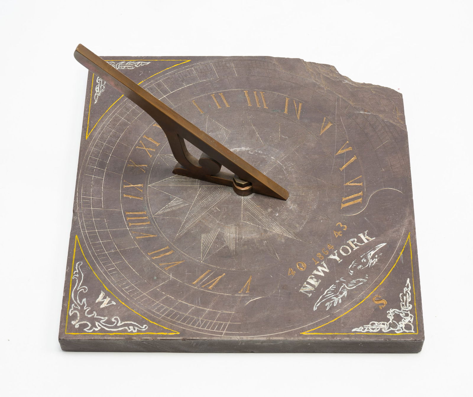 NEW YORK BRASS-MOUNTED SLATE SUNDIAL, DATED 1864.: American (New York), dated 1864. Slate with brass pointer. Nicely carved with compass star center. 12.5" square.Provenance: From the Lifetime Collection of the late Ken Hanna (Chester, New Jersey).