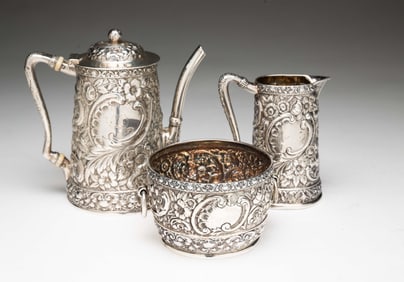 TIFFANY AND CO. STERLING SILVER REPOUSSE INDIVIDUAL TEA SERVICE.