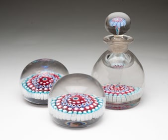 GLASS MILLEFIORI INKWELL AND TWO PAPERWEIGHTS.